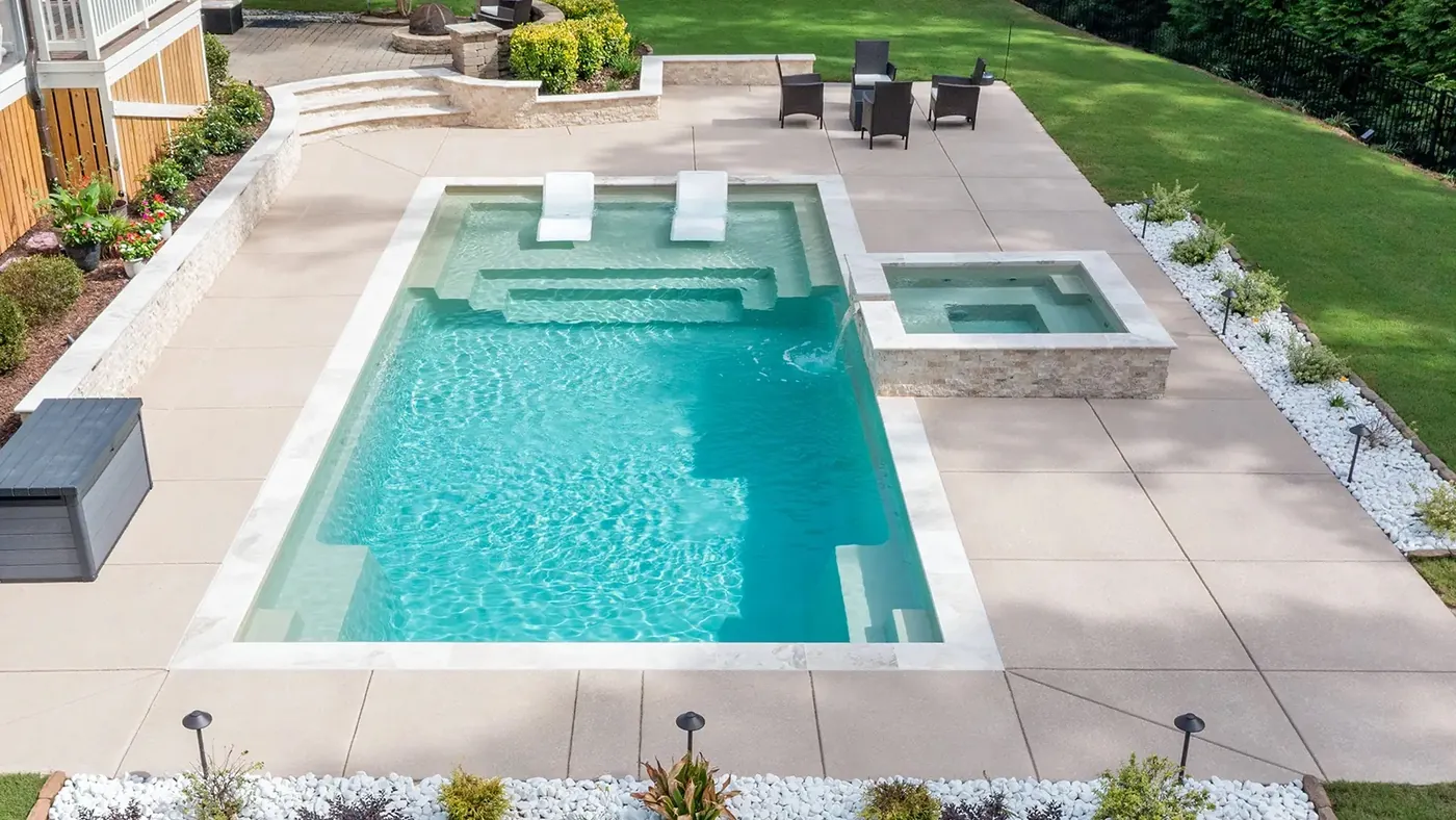 Fiberglass pool with raised spa and paver patio